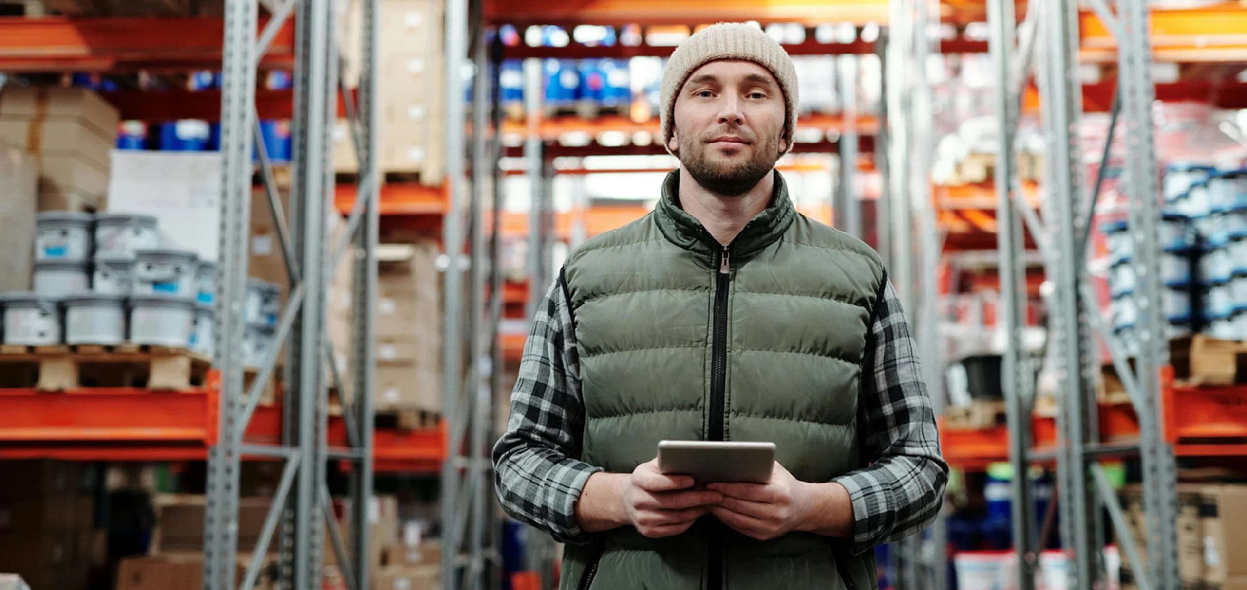 a man standing in warehouse with tablet