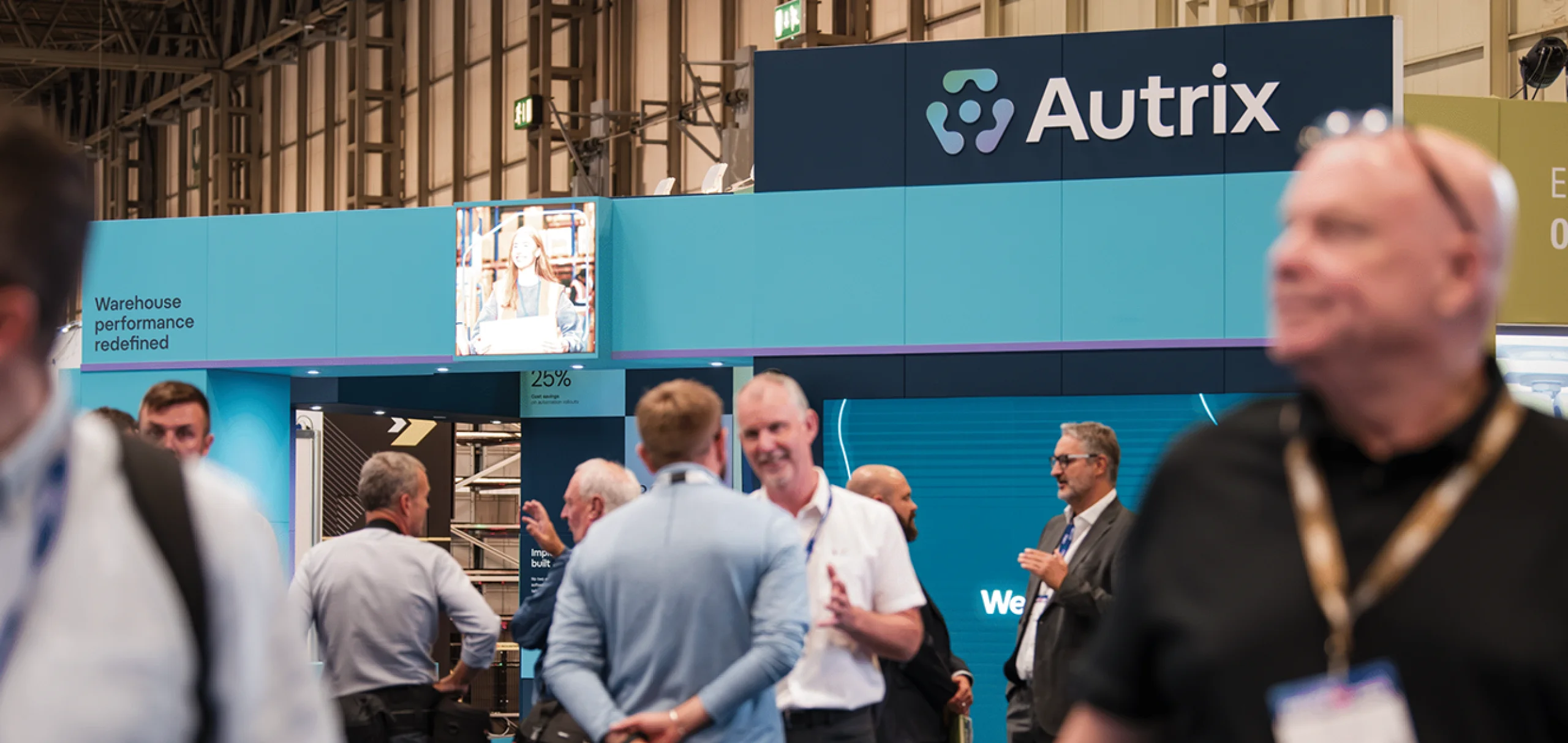 A crowd of people in front of the Autrix IMHX stand.