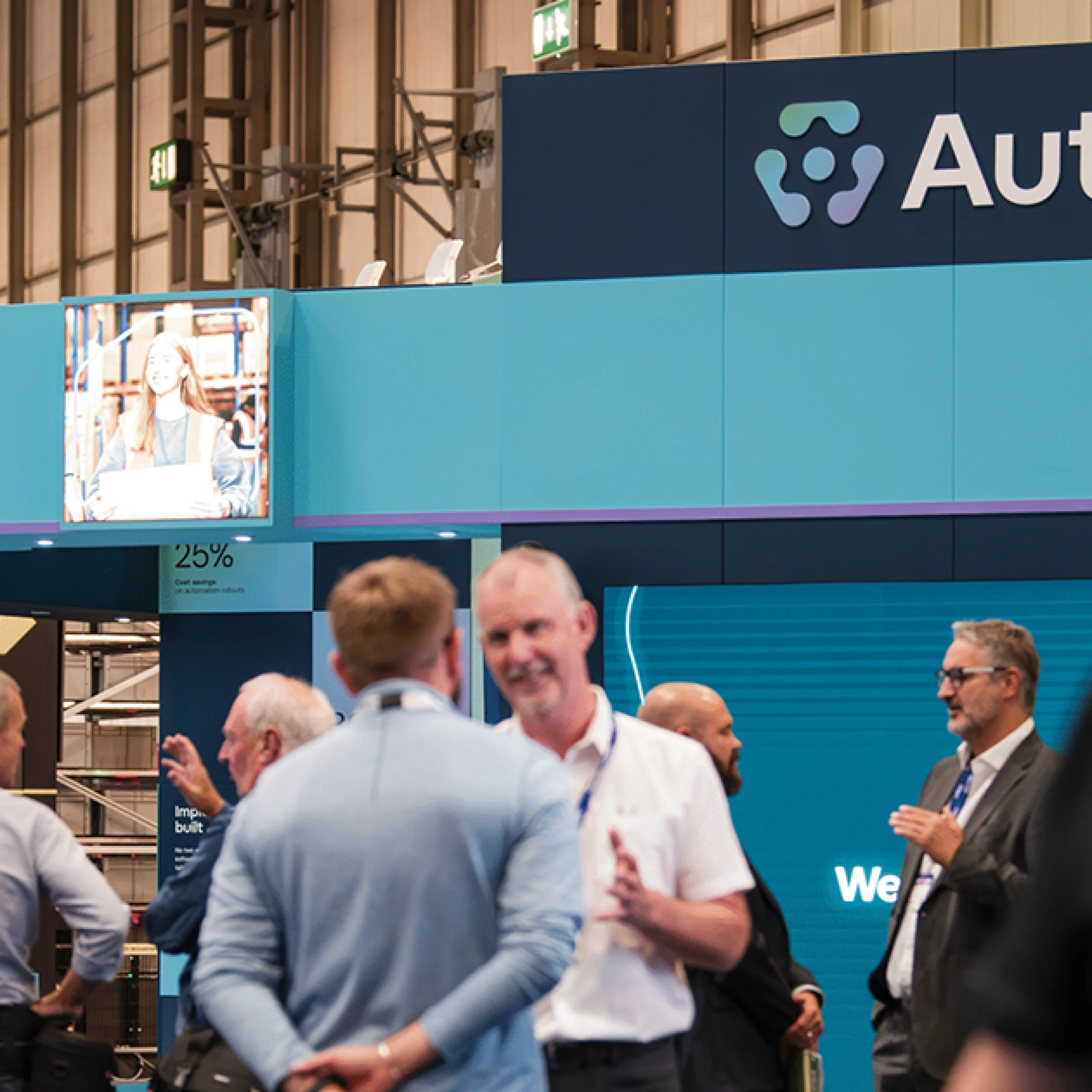 A crowd of people in front of the Autrix IMHX stand.